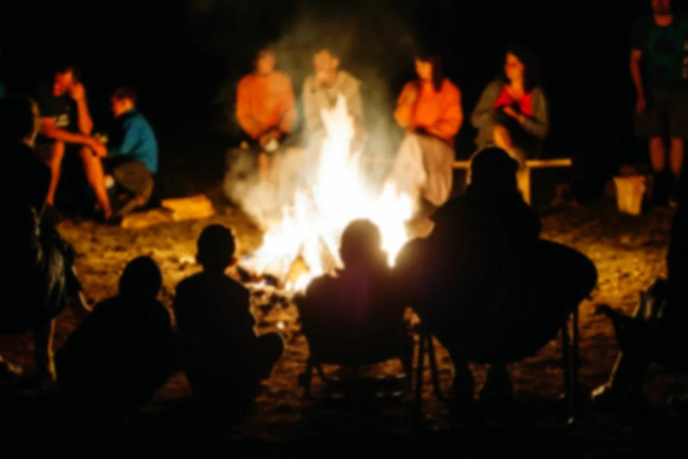 Campfire vs. Bonfire -people surrounding a bonfire