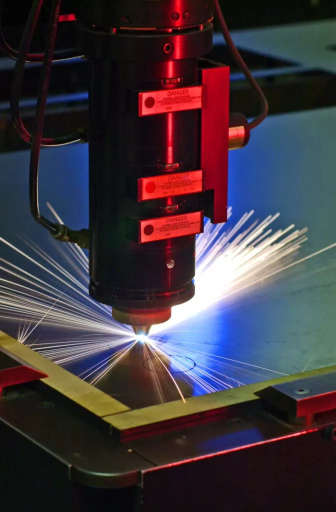 Industrial laser cutter with sparks flying 