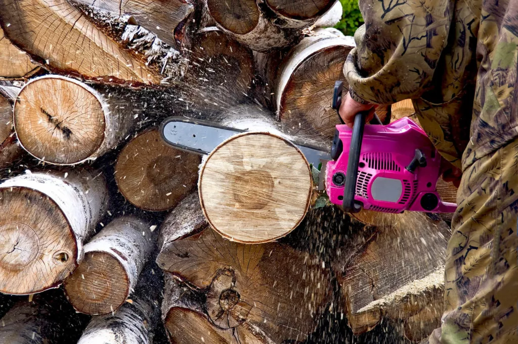 A man with a power saw cutting lumber