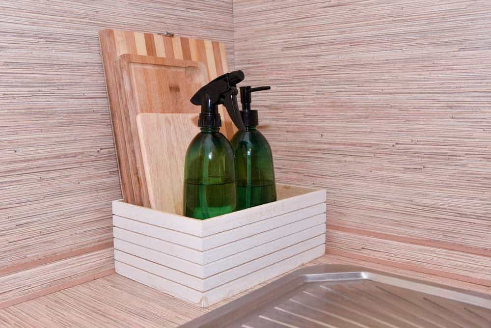 Cutting Board Wood Vs. Plastic: wood cutting boards with cleaning bottles