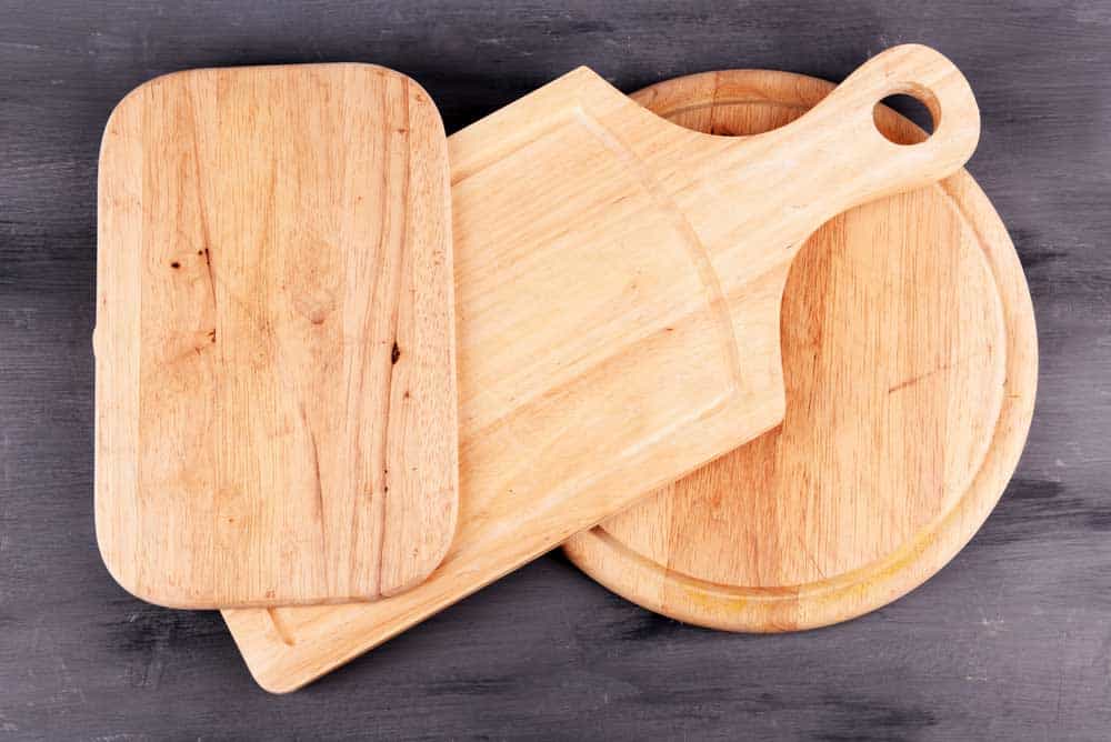 Two old cutting-boards with spices on top